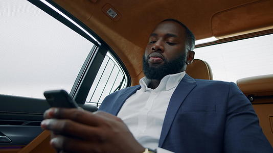 白领男性在汽车上用手机交流视频的预览图
