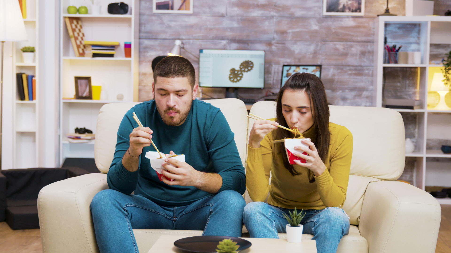 一对夫妇坐在沙发上用筷子吃面条视频的预览图
