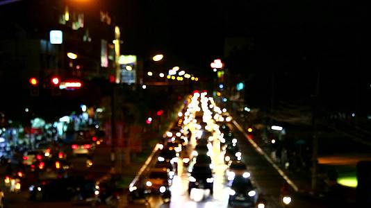 在黑轮转的高峰时间交通在夜间模糊了许多汽车视频的预览图