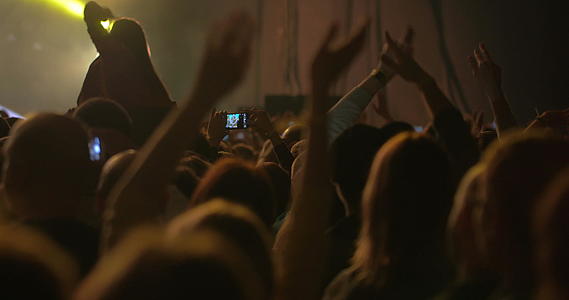男人用智能手机拍音乐会照片视频的预览图