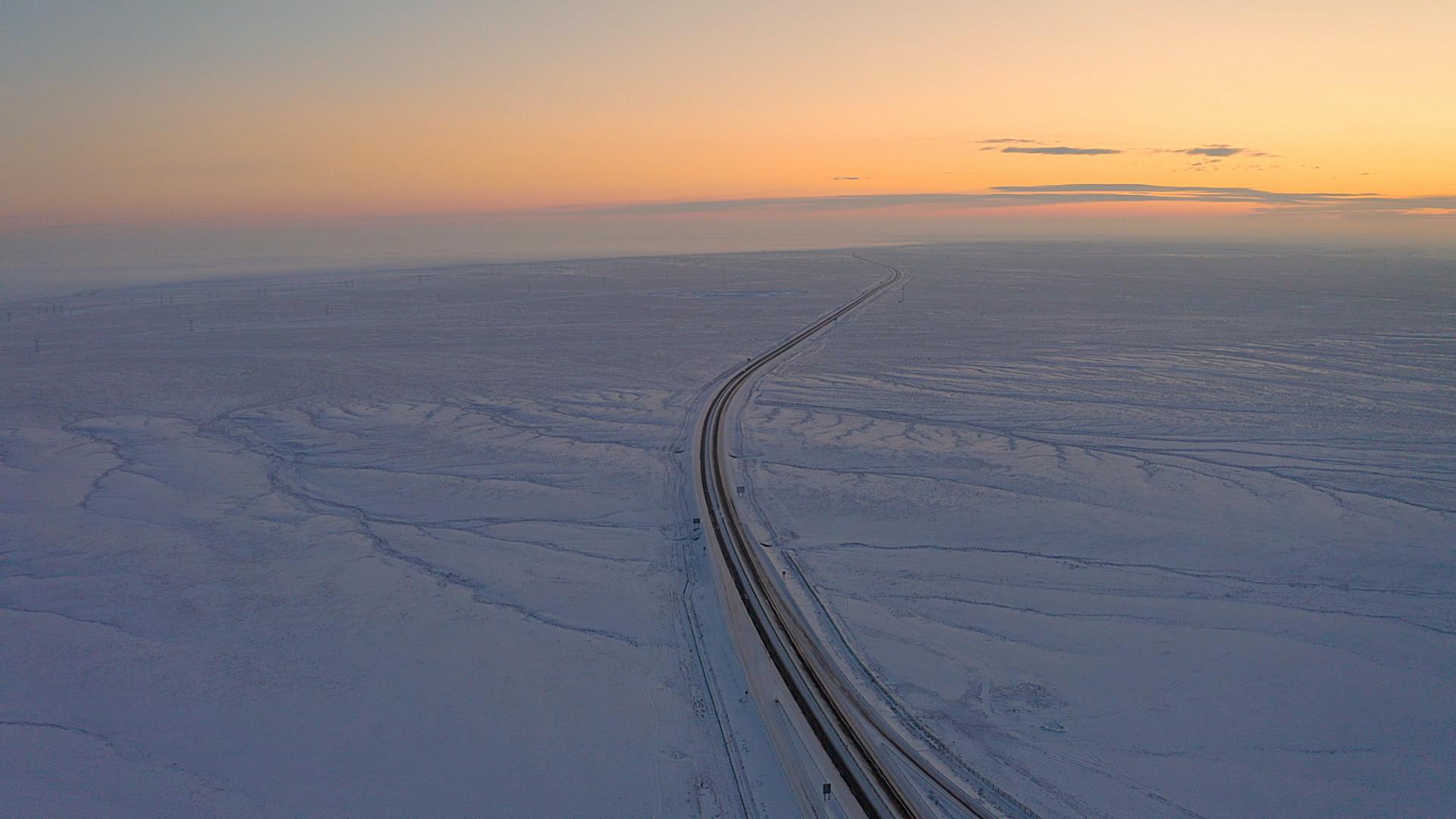 4K航拍新疆冬季雪原公路日落视频的预览图