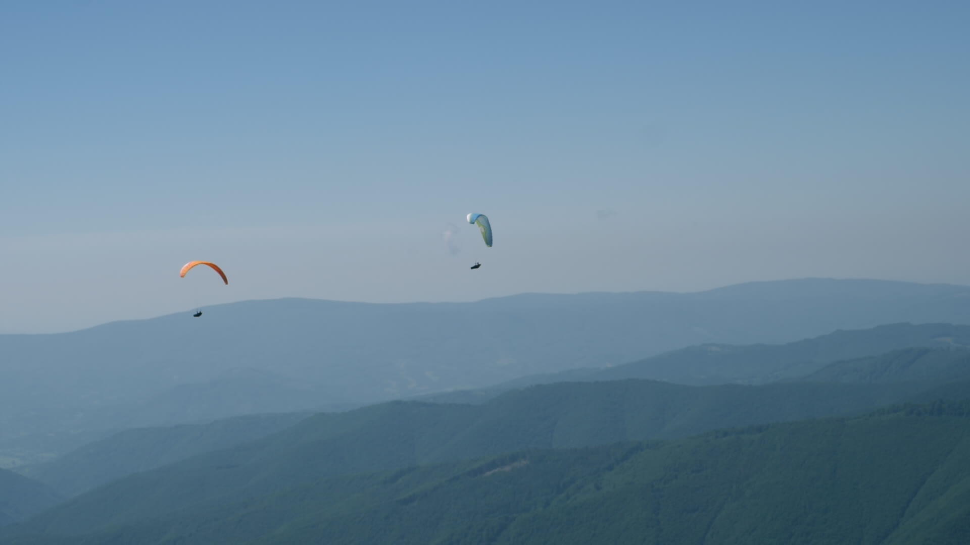 在阳光明媚的蓝天上玩滑翔伞视频的预览图