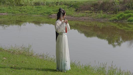 4k河边吹笛子的汉服女孩视频的预览图