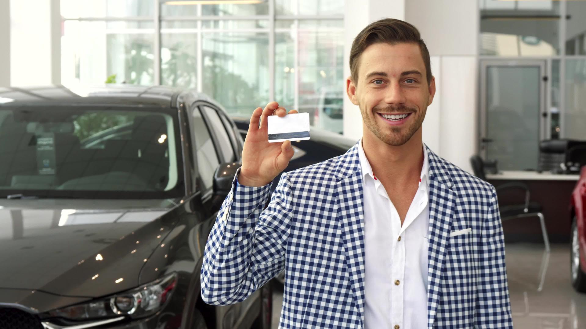 快乐的新车买家展示他的信用卡视频的预览图