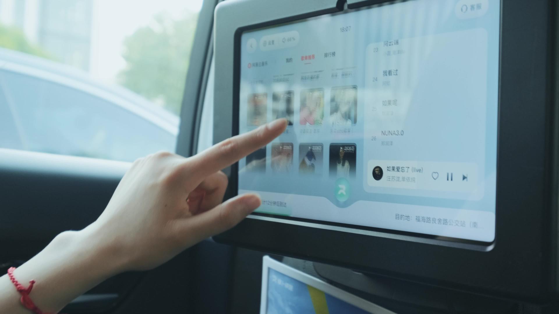 年轻女性操作萝卜出行无人驾驶汽车后智能屏幕视频的预览图