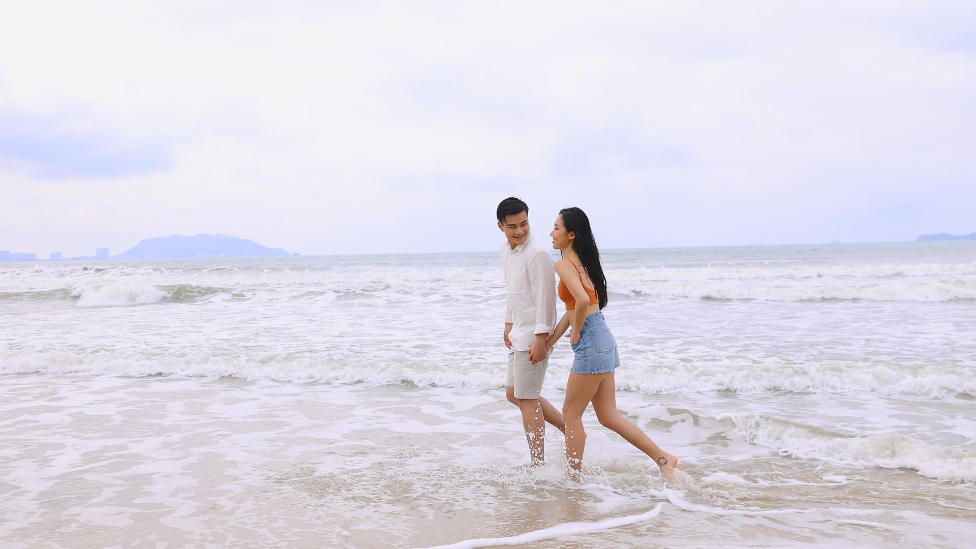沙滩边开心踏浪的情侣视频的预览图