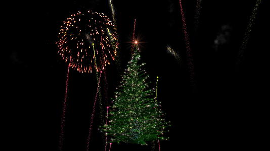 圣诞节灯光树在露烟花展示期间旋转奶茶茶视频的预览图