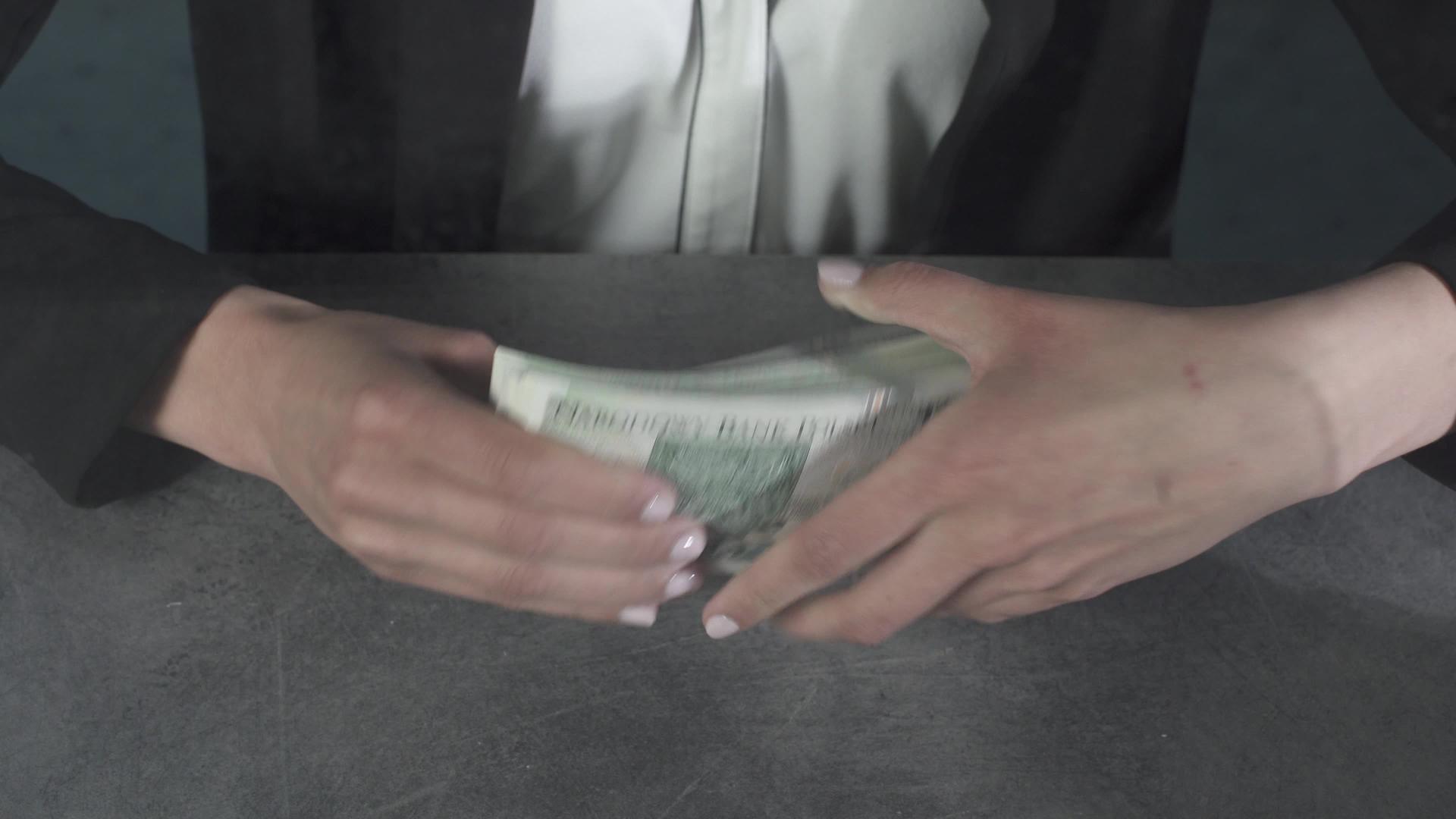 女人拿着一堆厚厚的钞票视频的预览图