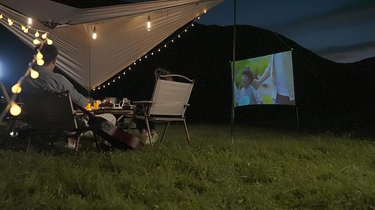 一家四口晚上露营看电影视频的预览图
