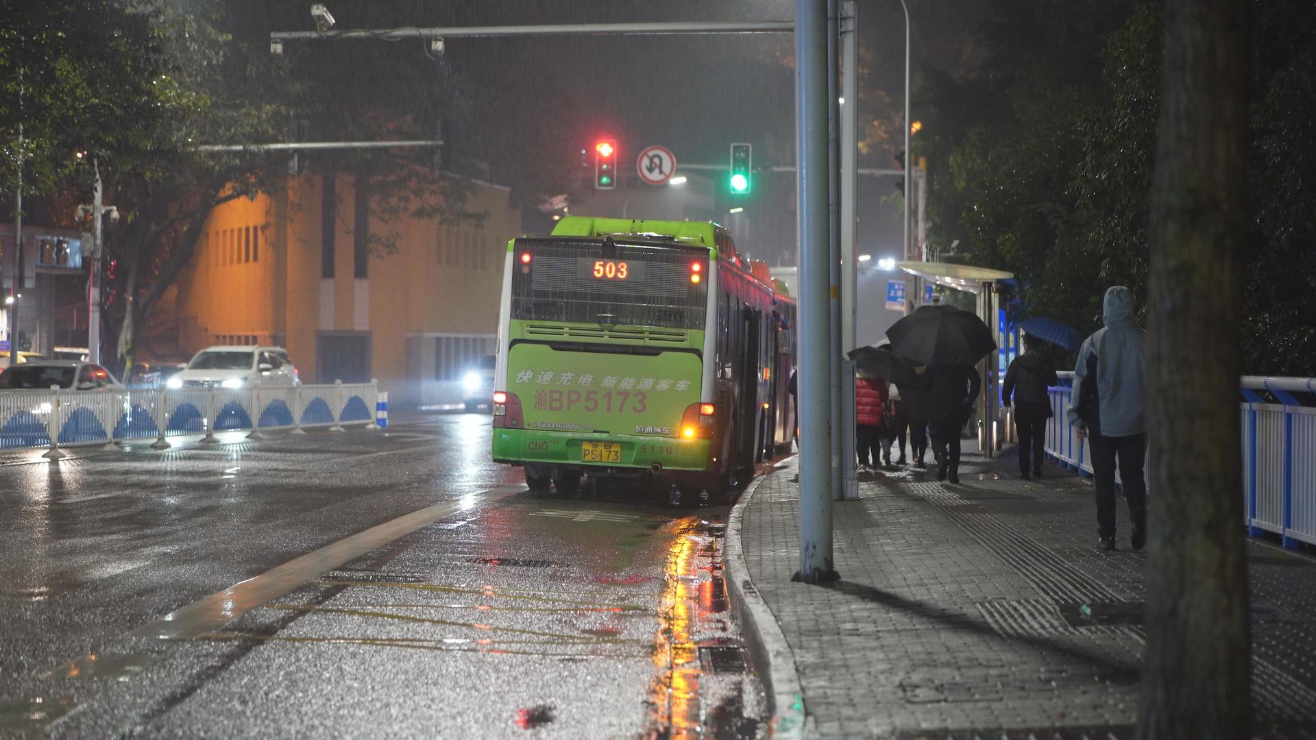 冬日雨夜中等待做公交车的职场上班人视频的预览图