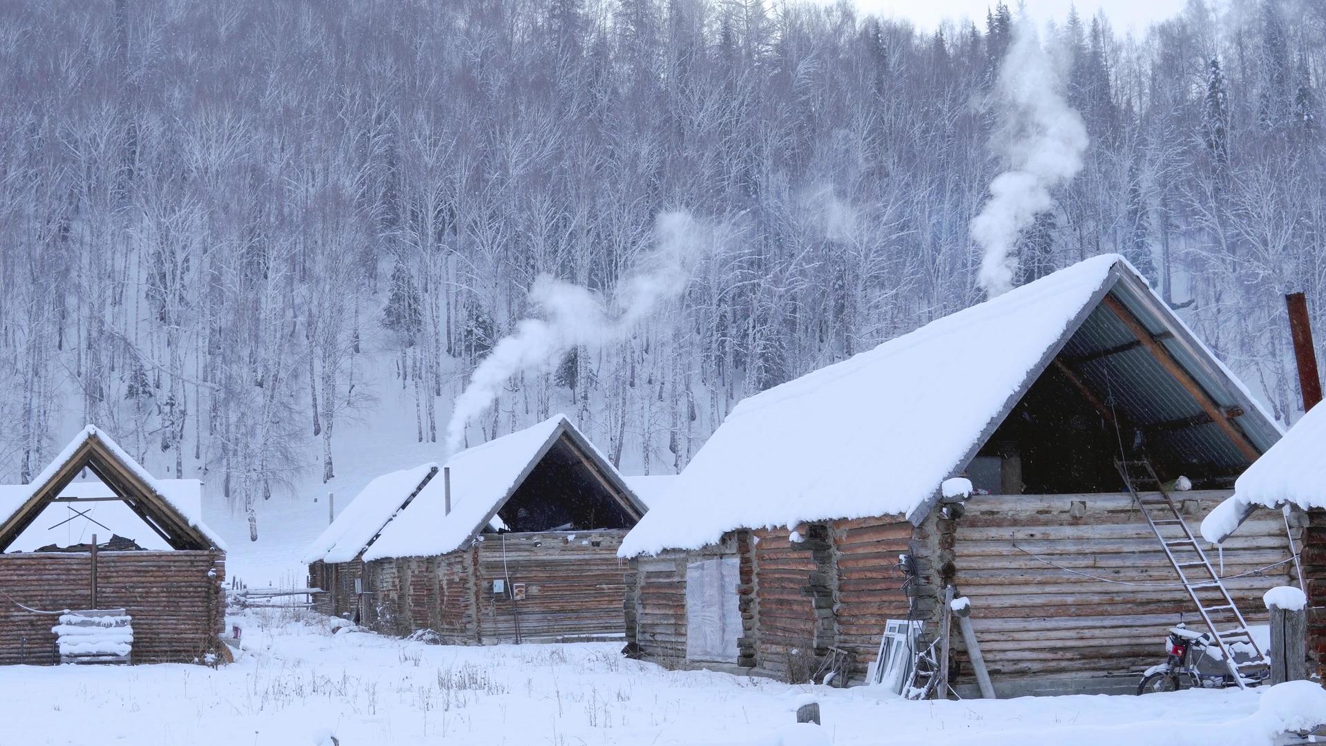 冬季东北新疆禾木村炊烟袅袅小木屋视频的预览图