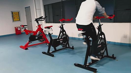 4K健身房锻炼训练健身动感单车运动视频素材视频的预览图