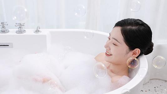 女生泡澡时悠闲地吹着泡沫视频的预览图
