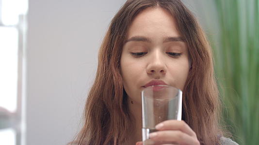 从浴室的玻璃杯中提取维生素胶囊和饮用水视频的预览图