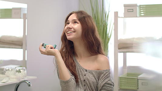 快乐的女人在浴室里用吸入器呼气新鲜视频的预览图
