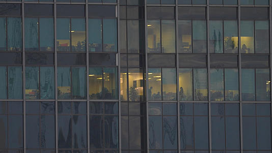 航拍城市办公楼夜景灯火通明的办公室加班工作4k素材视频的预览图