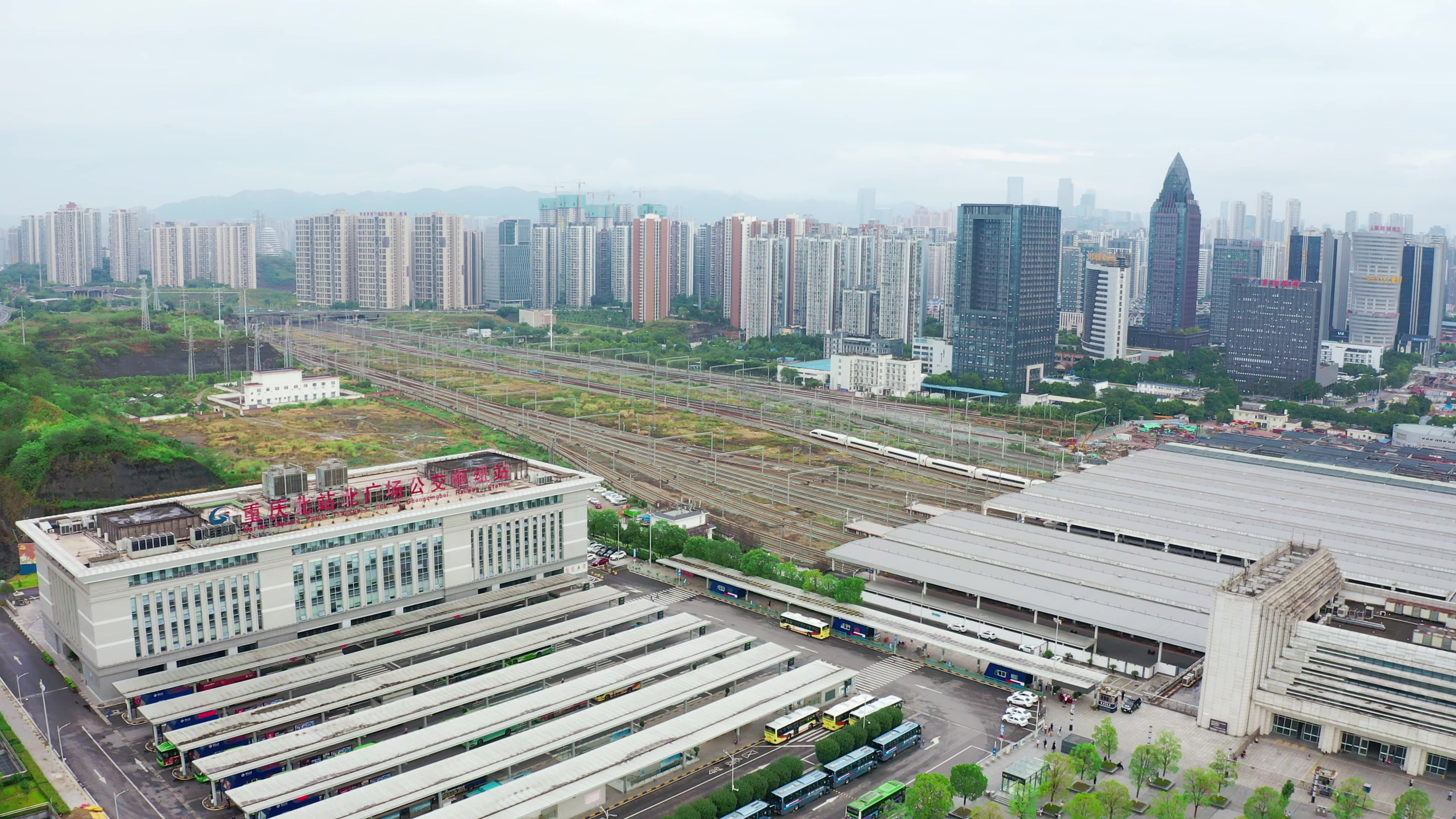 4K实拍航拍高铁驶出高铁站重庆北站视频素材视频的预览图