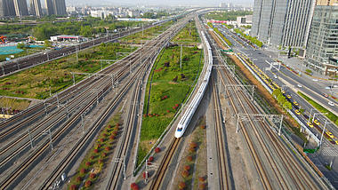 4k航拍南京南站高铁行驶出站行驶途中鸟瞰视频视频的预览图