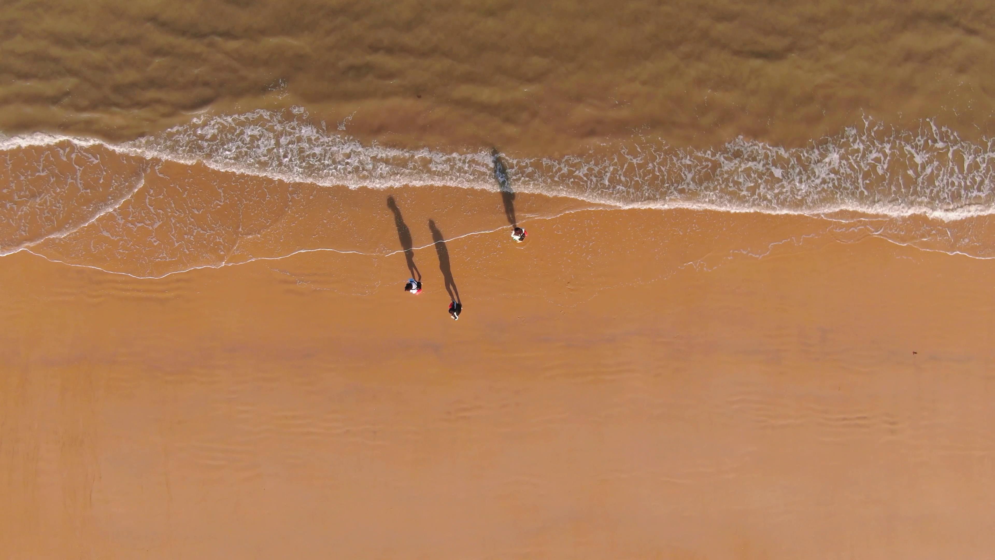 4k海边沙滩美女行走旋转航拍视频的预览图