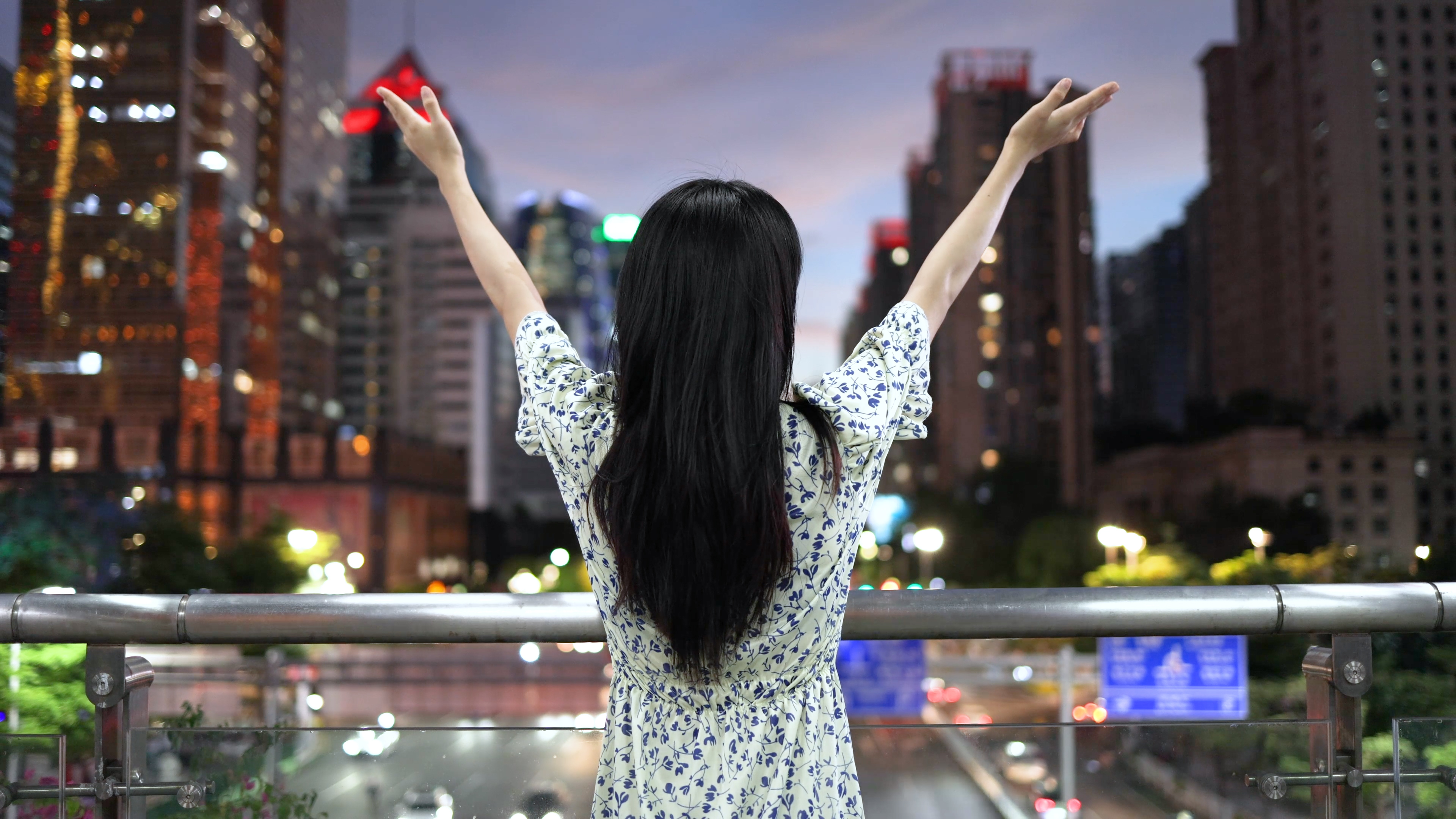 4K年轻美女张开双臂拥抱希望城市夜景背影视频的预览图