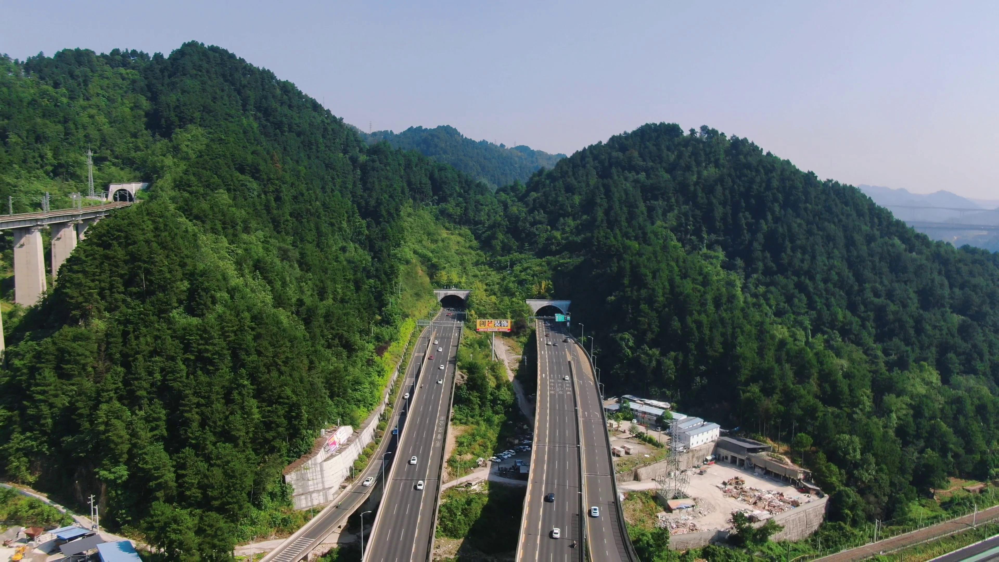 4K航拍高速路车流穿山隧道口交通视频视频的预览图