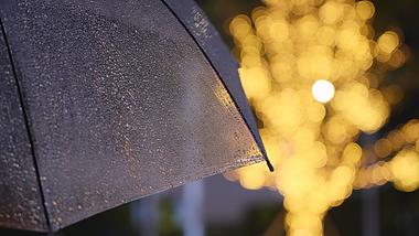 4k夜晚灯饰下透明雨伞雨滴滑落空镜意境视频的预览图
