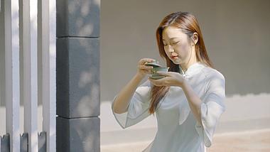 4K庭院落日美女品味茶水享受视频的预览图