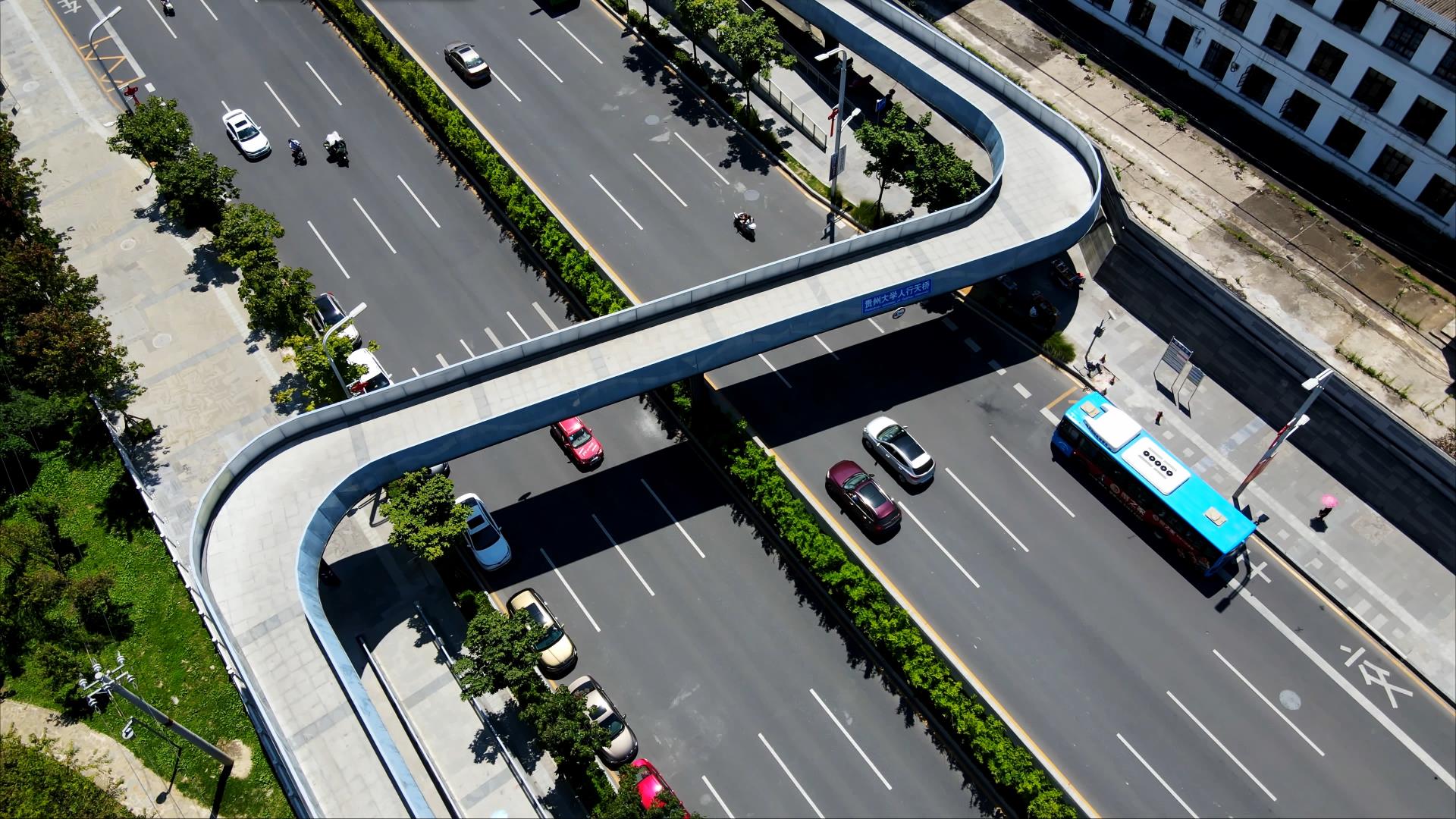 4K航拍城市人行天桥下公路车流来往实况视频的预览图