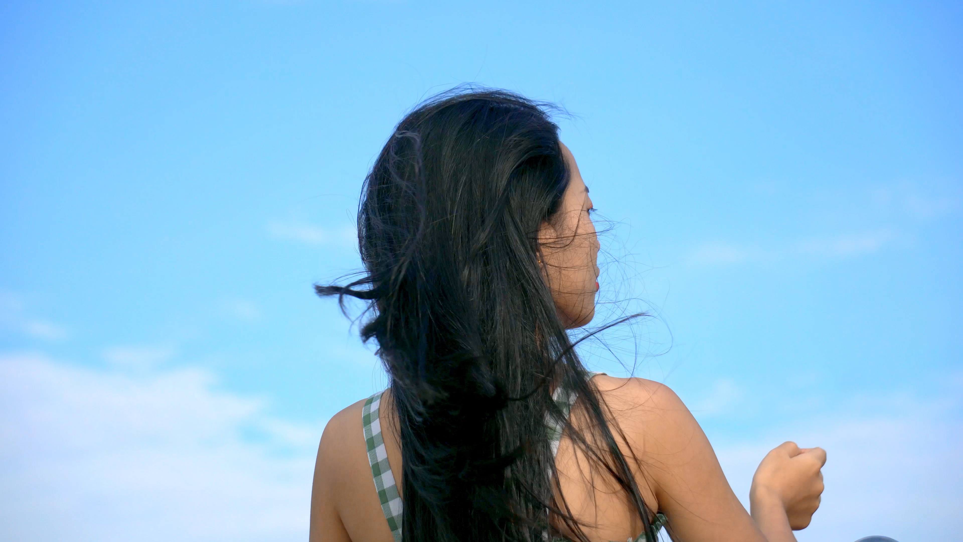 4K实拍天空下的风吹美女头发背影视频的预览图