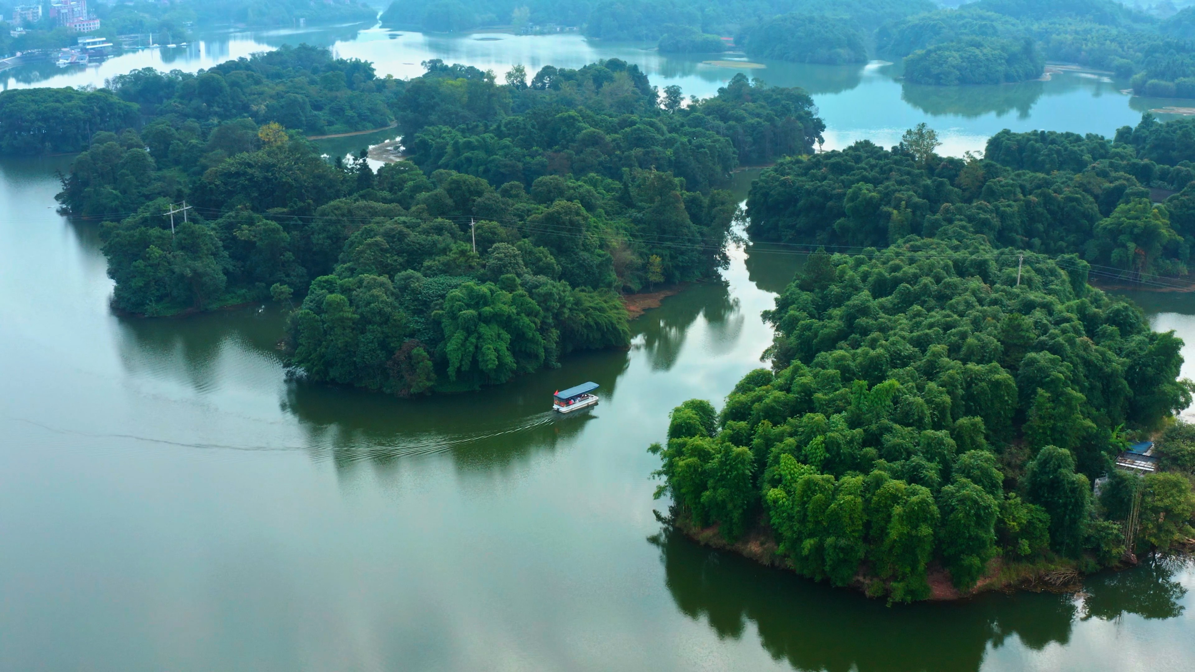 4k航拍碧绿湖水上的观景观光小船游船视频的预览图