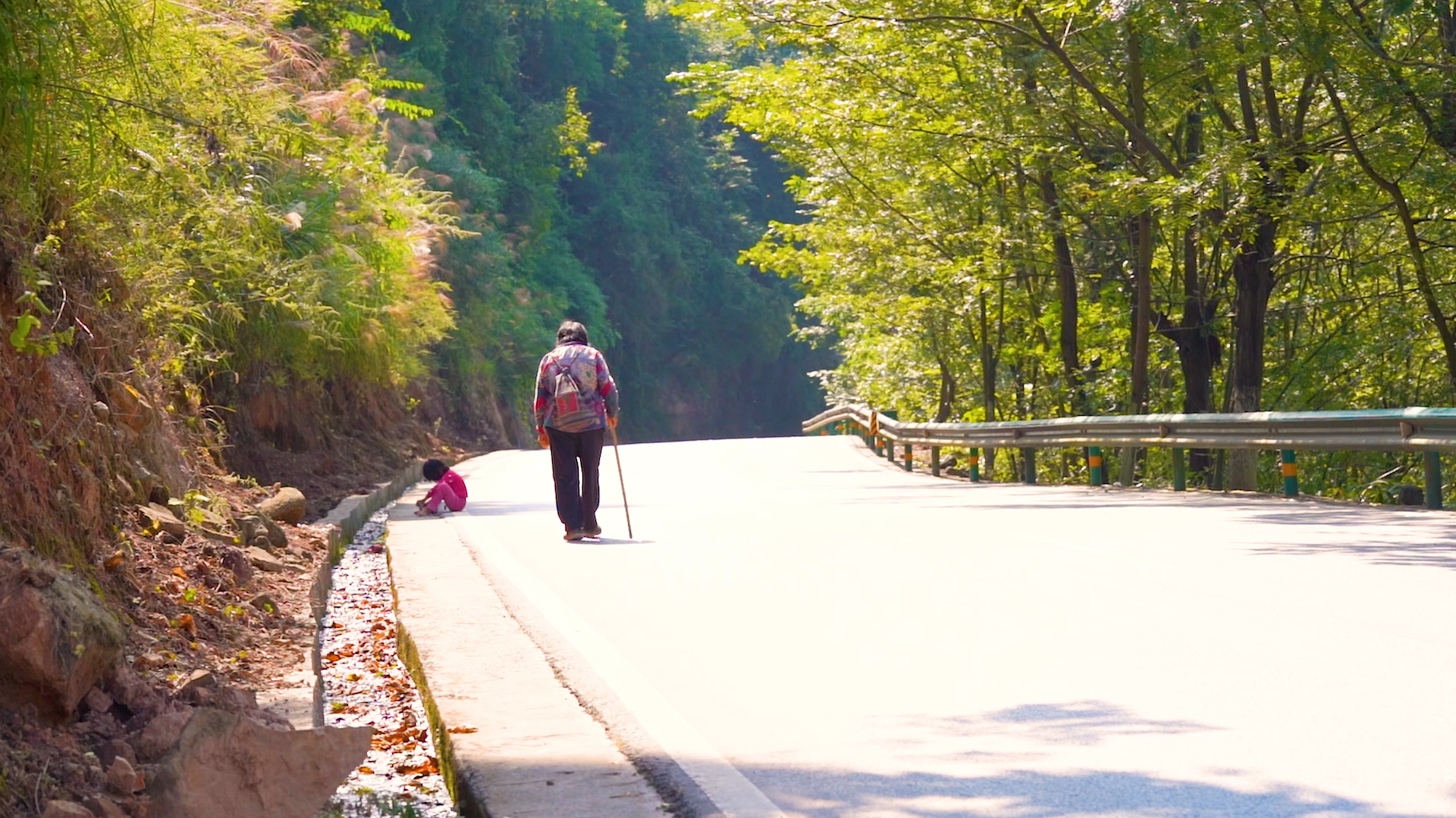 4k实拍山间公路行走的老人背影意境视频的预览图