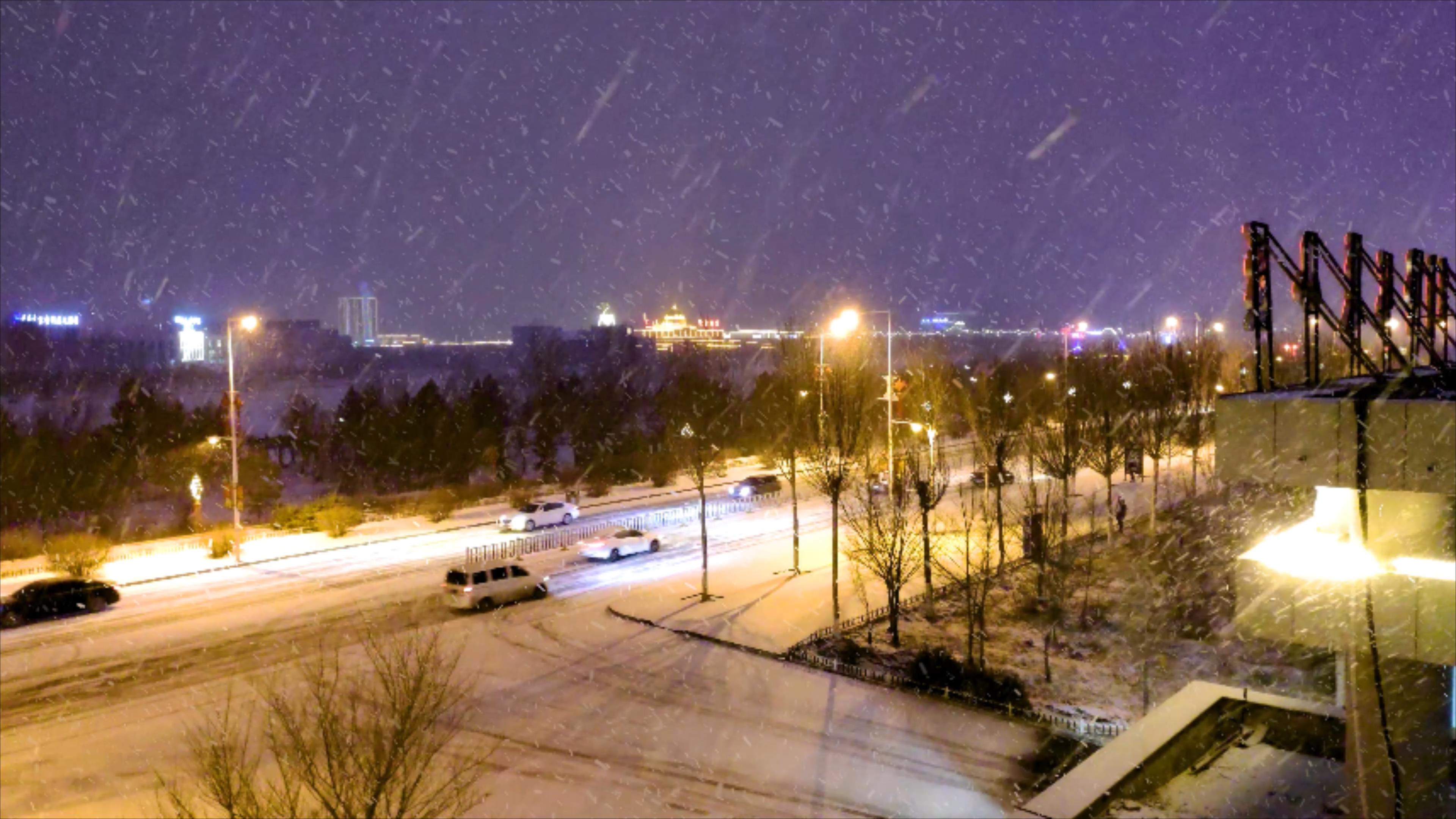 4k拍摄北方城市冬天夜晚下雪的情景视频的预览图
