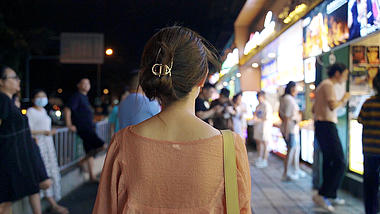 4K升格视频女孩行走在小吃街夜景视频的预览图